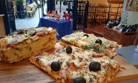 Close up of pizza slices on the counter of caf and deli Madame Fromage, Cardiff